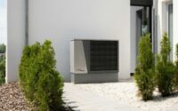 a air conditioner sitting on the side of a building